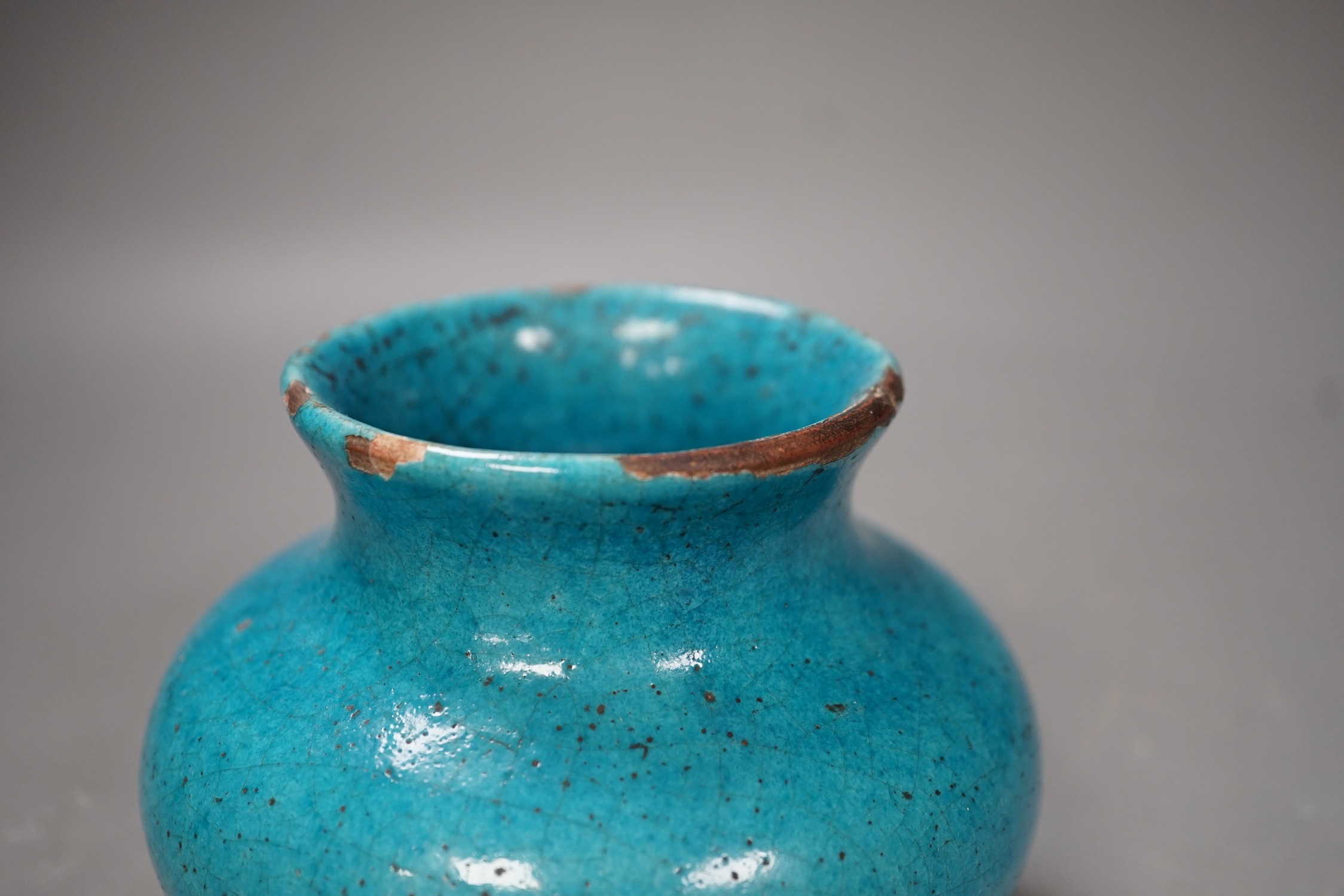 A Kashan style turquoise glazed vase. 10cm tall